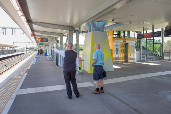 Customer being assisted on platform by station staff