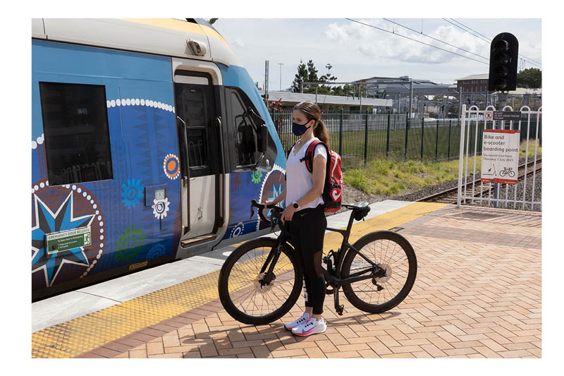 Lady waiting to board first carriage with bike